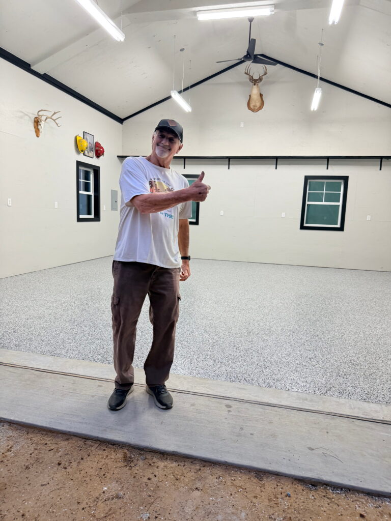 Happy customer after epoxy flooring installation in Helotes, TX