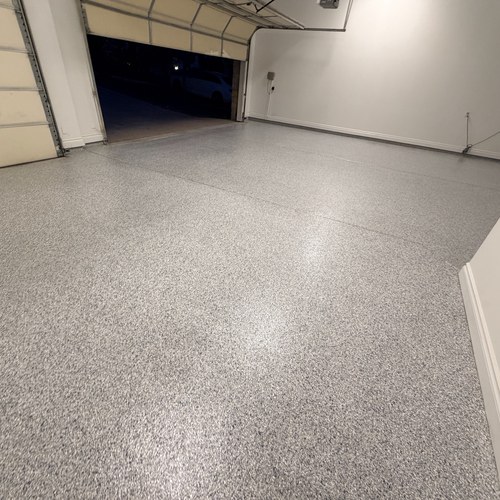 Flake epoxy garage floor lit at night in San Antonio, TX